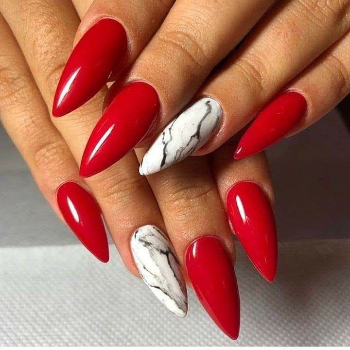 Bold Red Almond Nails with Chic Marble Accent Blend Elegance and Modernity.