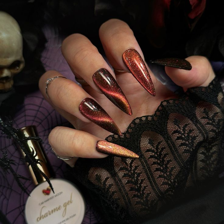 Dramatic Gradient Long Stiletto Nails: Deep Red to Shimmering Black with Holographic Glitter in a Gothic Aesthetic.