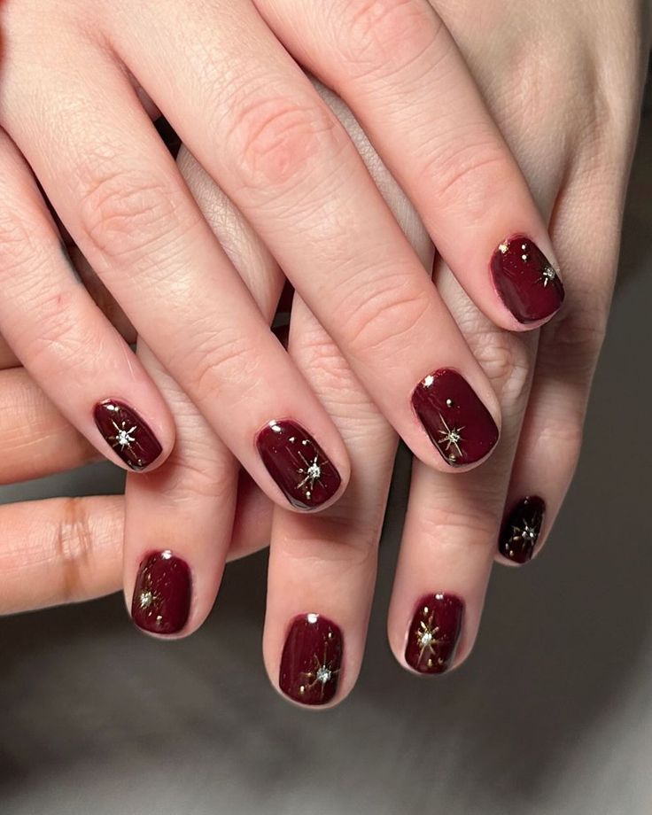 Chic Elegant Burgundy Nail Design with Gold Star Accents