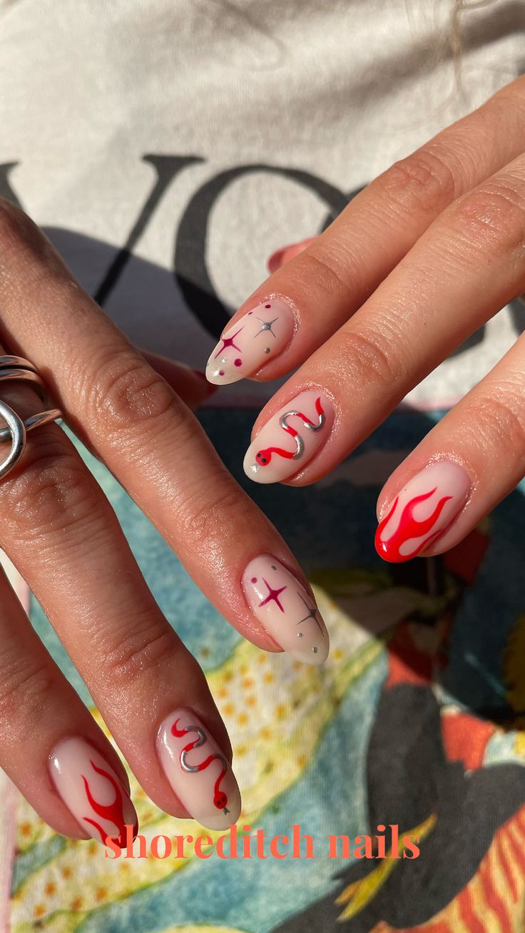 Bold Flame-Inspired Nail Design: Edgy Artistry Meets Trendy Chic with Red and Beige Hues.