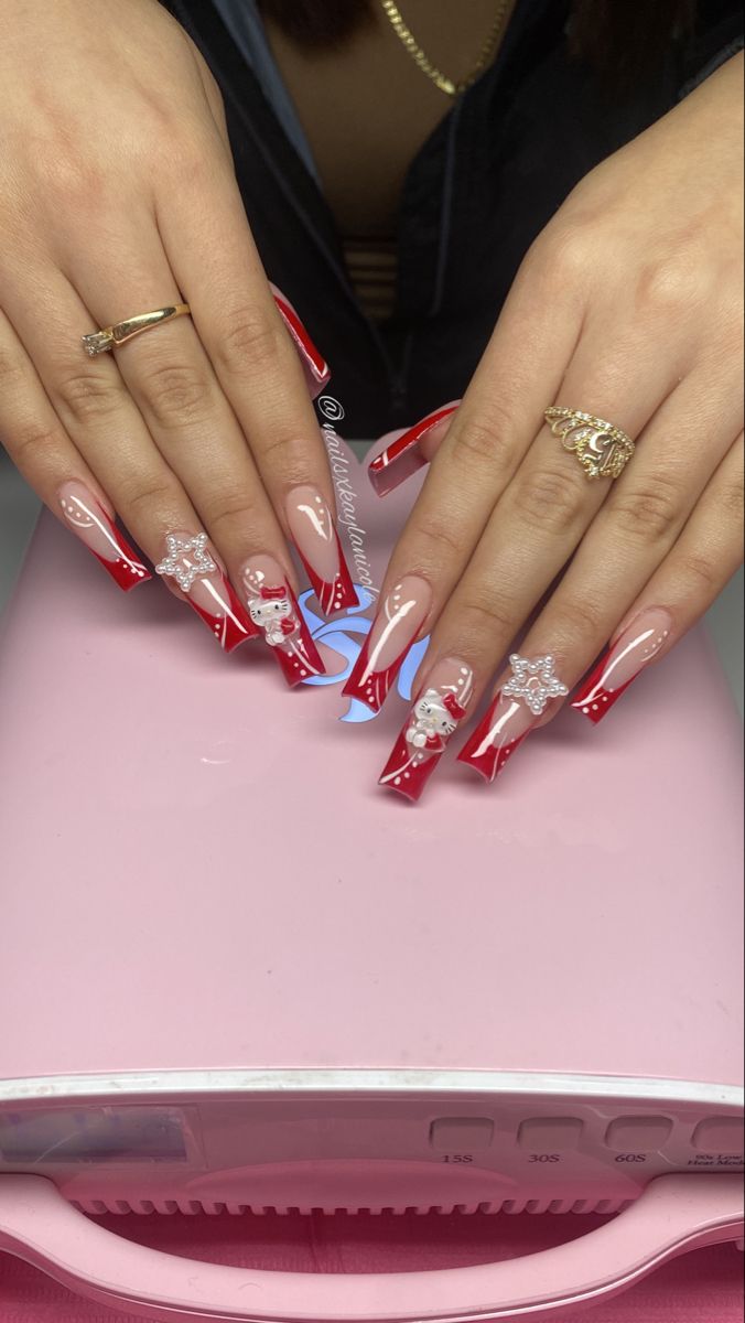 Elegant Holiday Nail Design: Striking Red and Nude Tones with Whimsical Accents.