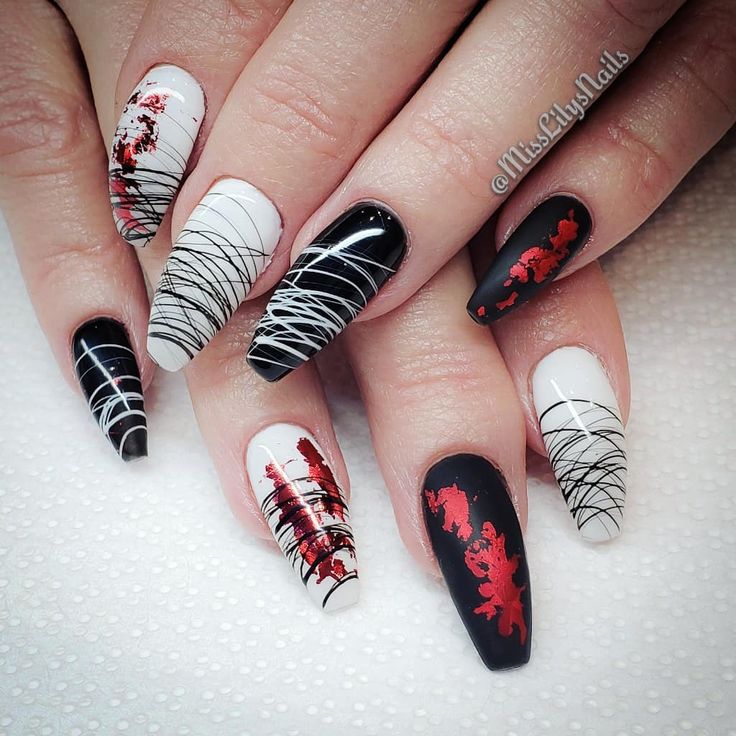 Bold Black, White, and Red Nail Design with Intricate Line Work and Dynamic Finishes.