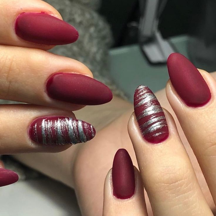 Chic Matte Burgundy Nails with Playful Silver Stripes for a Sophisticated Look.