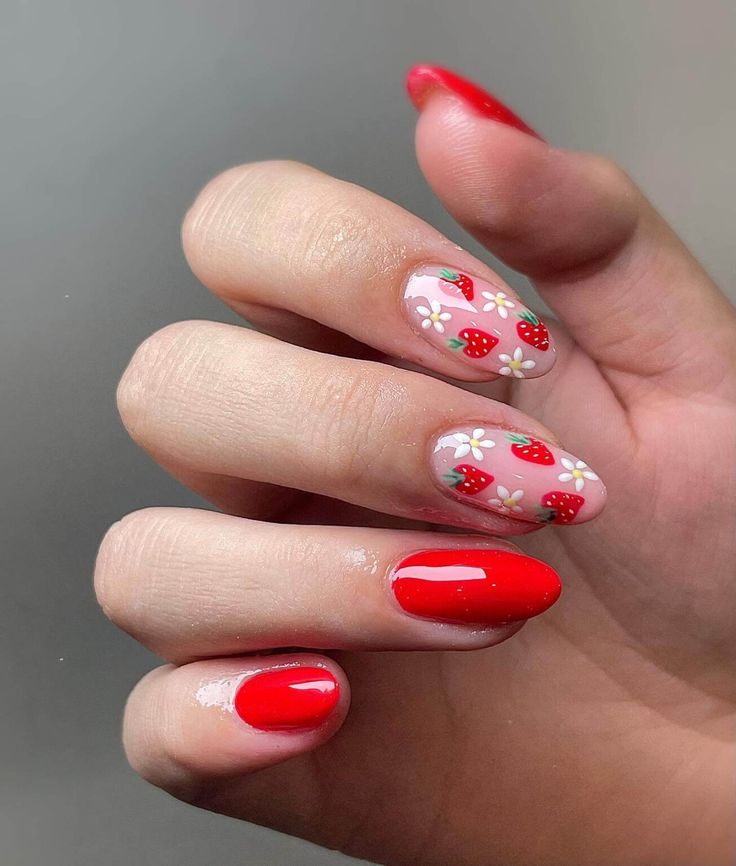 Vibrant Summer Nail Design with Bold Colors and Playful Strawberry Patterns.