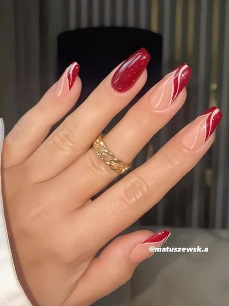 Chic Nail Design: Bold Deep Red Tips with Soft Nude Base and Intricate White Swirls