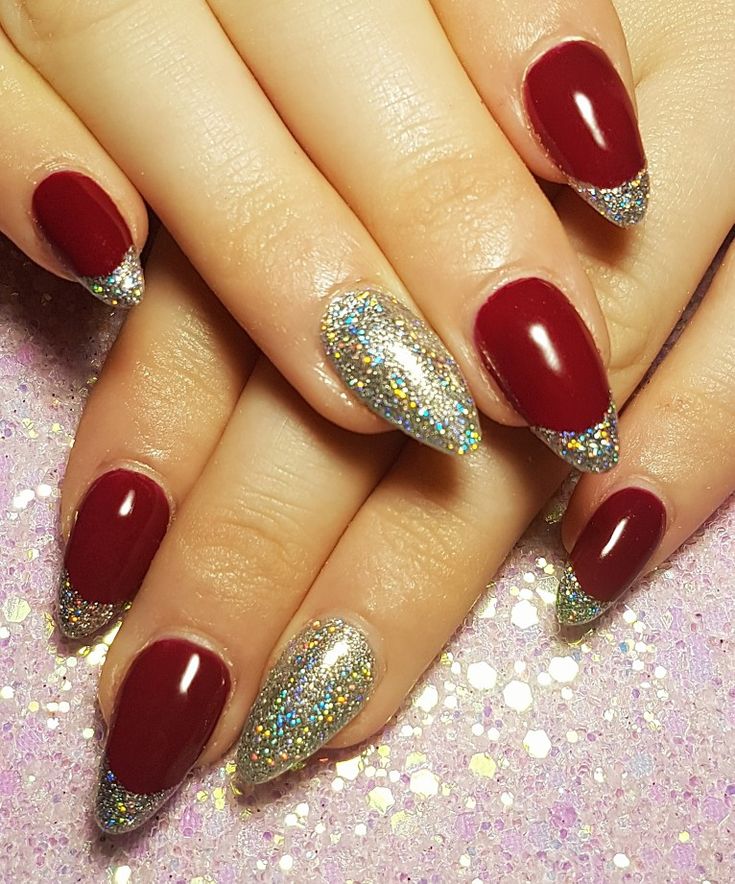 Chic Burgundy Almond Nails with Sparkling Silver Tips and Holographic Accents.