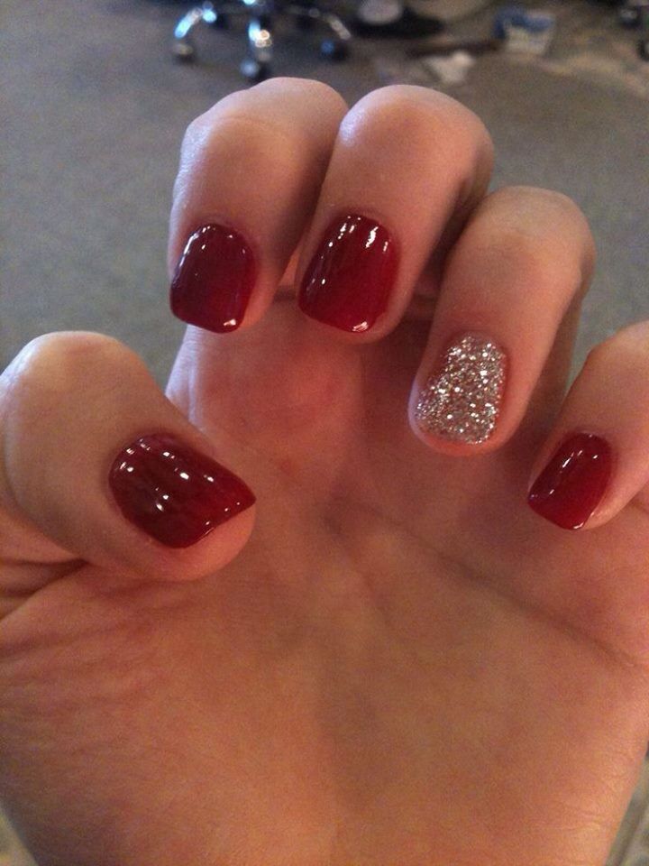 Sophisticated Crimson Nail Design with Sparkling Silver Accent for Any Occasion.