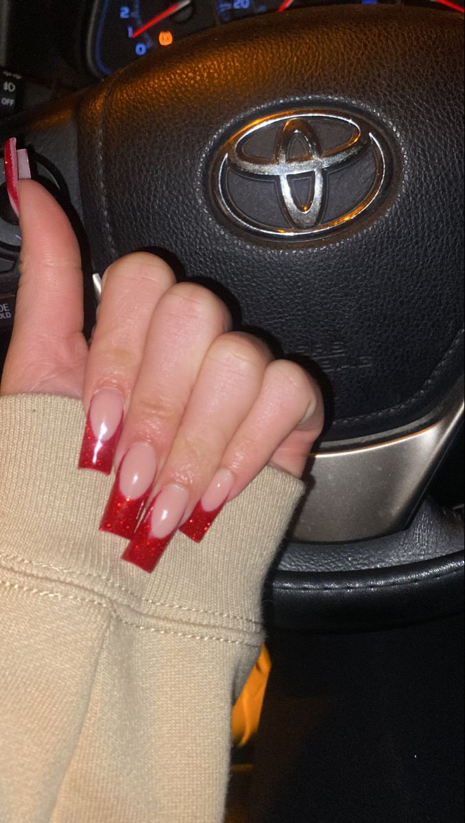 Elegant Nail Design: Stylish Nude and Bold Red Combination with Glossy Tips.