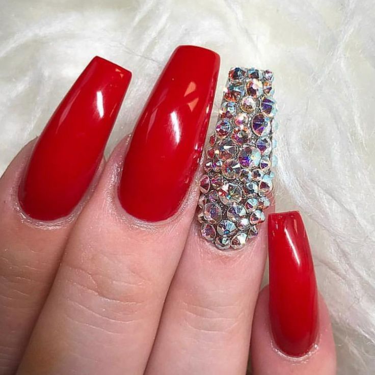 Glamorous Bold Red Nails with Rhinestone Accent for Modern Elegance.