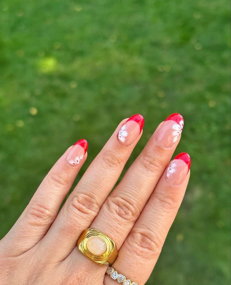 Chic Red French Tip Nails with Delicate Floral Accents for Any Occasion