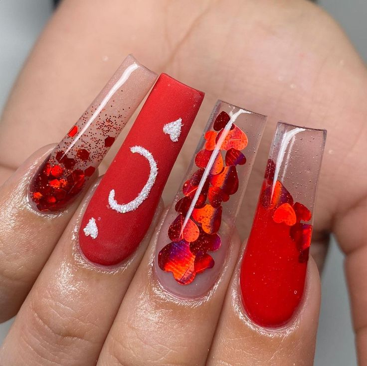 Vibrant Red Nail Design: Glossy Finish with Festive Embellishments and Modern Patterns.