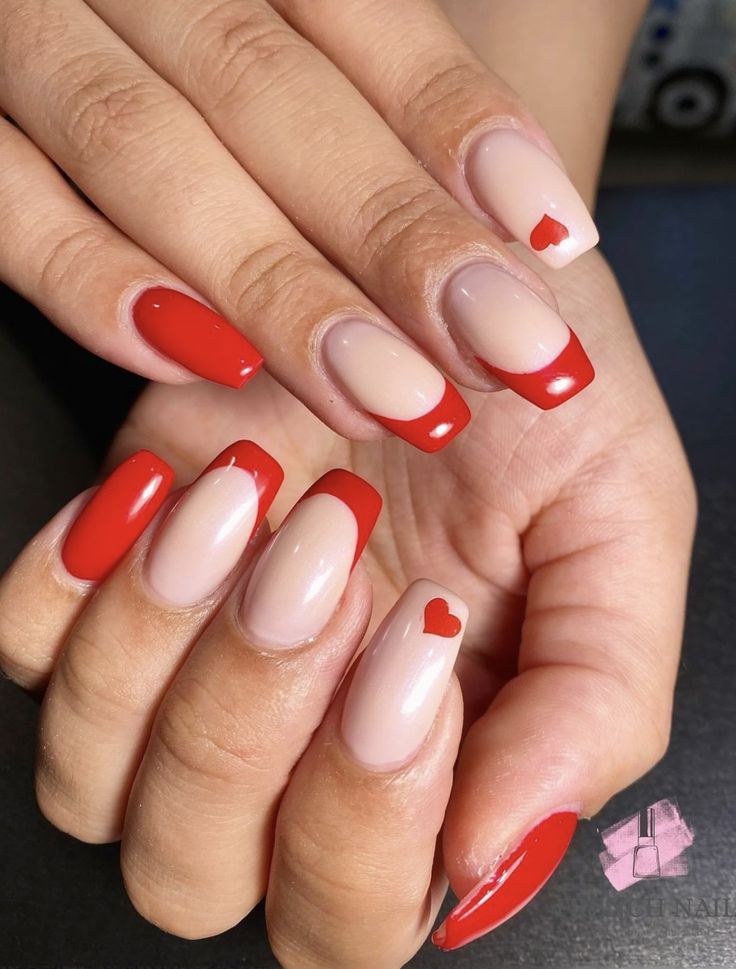 Chic Nail Design: Nude and Vibrant Red with Heart Accents and Modern Tips