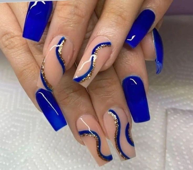 Elegant Blue and Nude Nails with Glossy Tips and Gold Accents for a Glamorous Look.