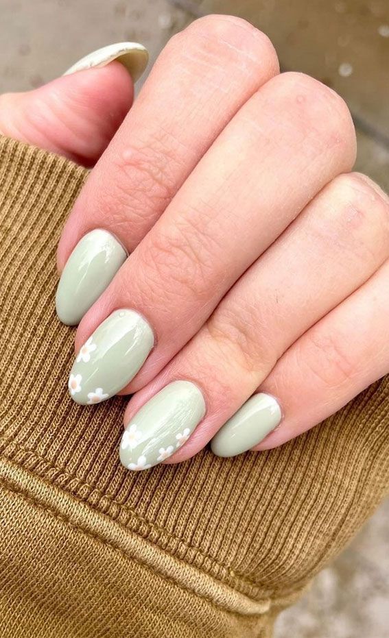 Charming Sage Green Nail Design with Delicate Floral Accents for a Playful Aesthetic.