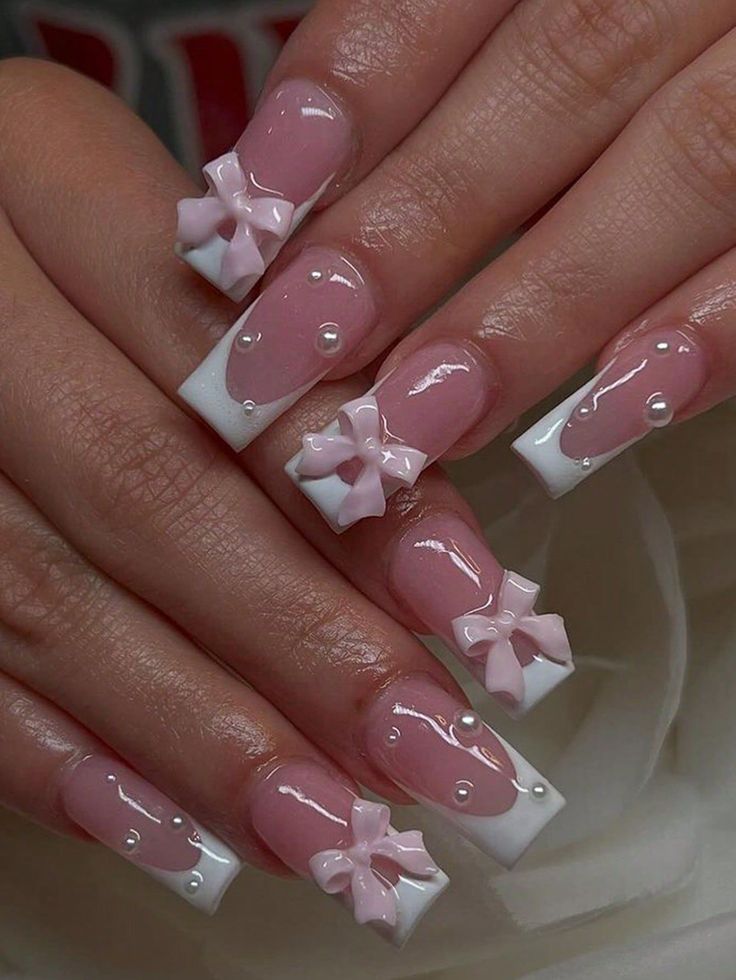 Charming Nail Design: Elegant White Tips, Soft Pastels, and Whimsical Pearl Accents.