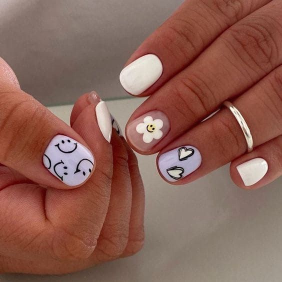 Cheerful Colorful Nail Design: Light Lavender Base with Smiley Faces and Charming Accents.