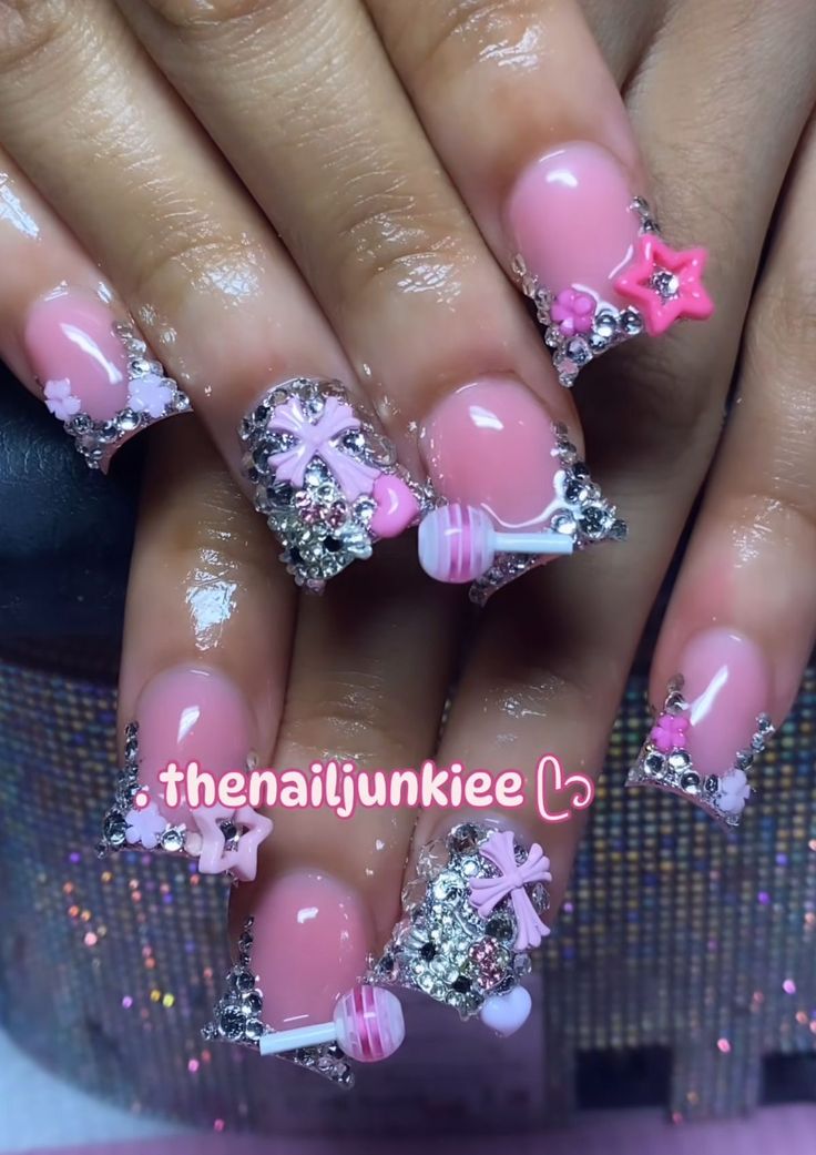 Whimsical Chic: Soft Pink Nail Art with Metallic Accents and Colorful Charms