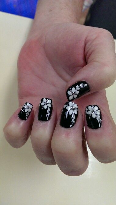 Elegant Black and White Nail Design with Floral Patterns for a Bold, Glamorous Statement.