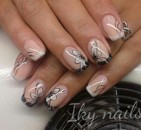 Sophisticated Nude and Black Floral Nail Design with Glossy Finish.