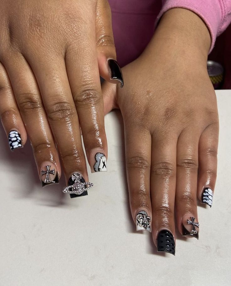 Bold Black and White Nail Design: Geometric Patterns and Intricate Embellishments.