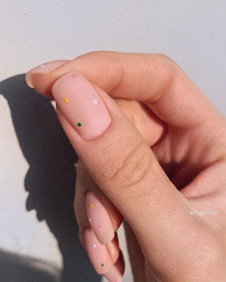 Chic Nail Design: Soft Pink Base with Playful Multi-Colored Dots for Versatile Style