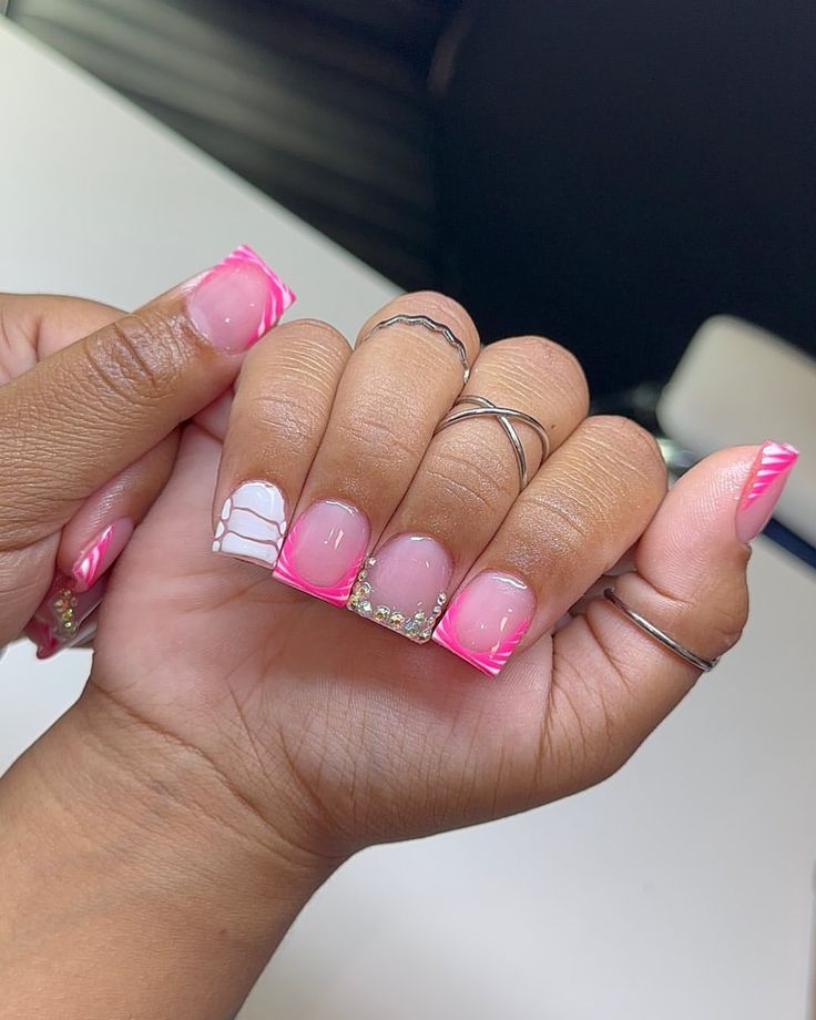 Playful Chic: Vibrant Pink and Soft White Nail Art with Sparkling Embellishments