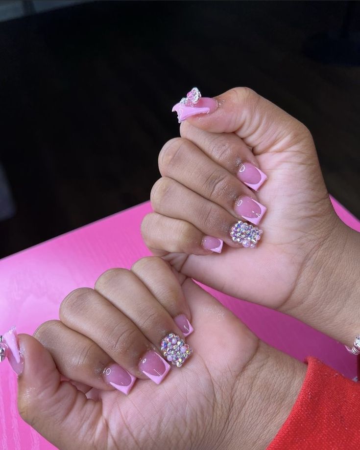 Charming Elegant Pink Nail Design with Glossy Finish and Playful Embellishments.