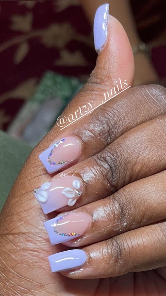 Chic Lavender and Nude Nail Design with Floral Details and Shimmering Accents.