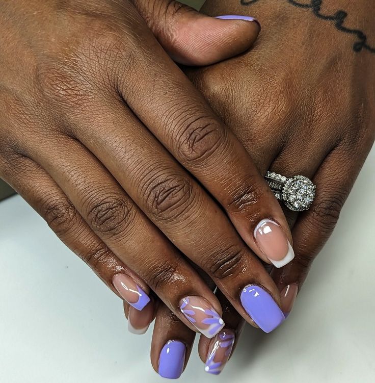 Sophisticated Lavender and Nude Nail Design with Artistic French Tips and Shine.