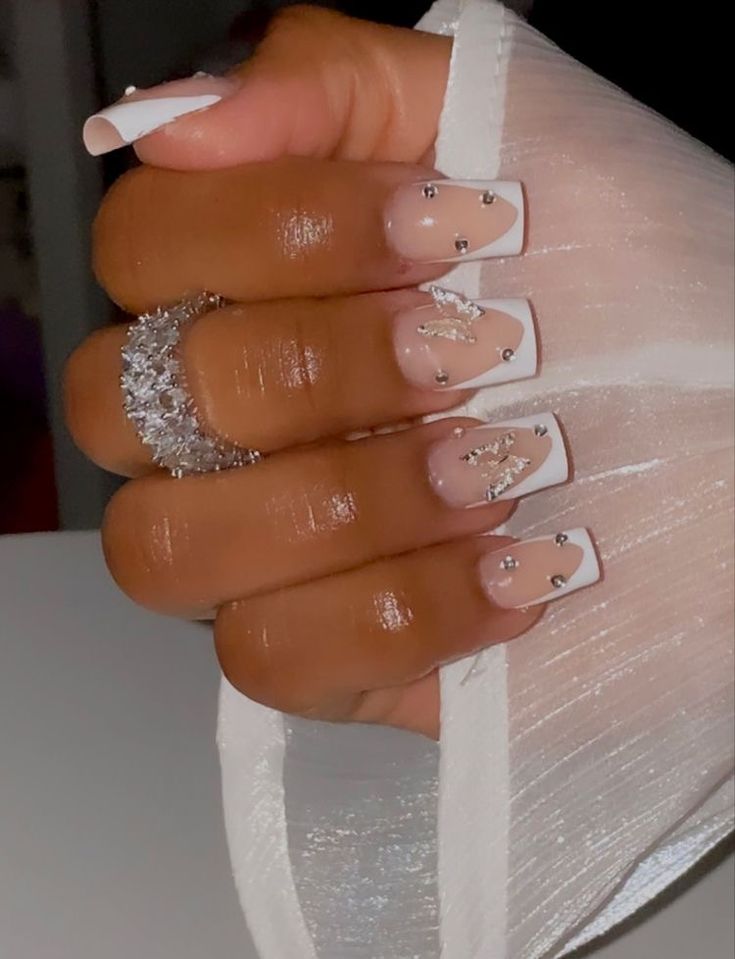 Chic Natural and White Tip Nail Design with Glamorous Rhinestone Embellishments for Elegant Occasions.