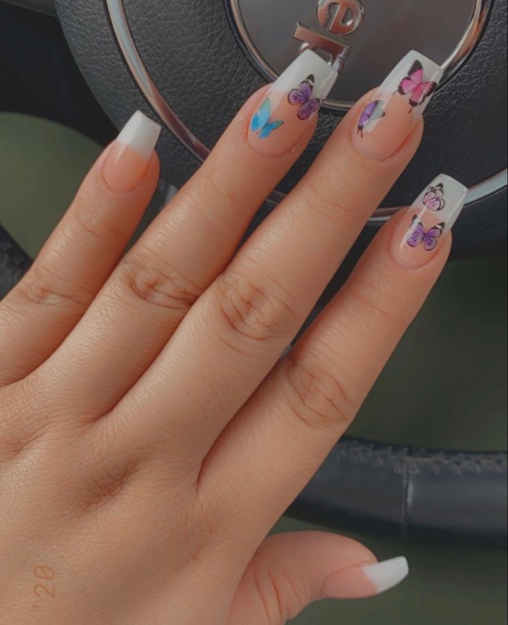 Whimsical Butterfly Nail Art with Elegant French Tips and a Nude Base.