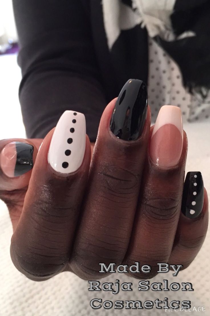 Striking Bold Nail Design: A Modern Contrast of Black and Nude with Playful Patterns.