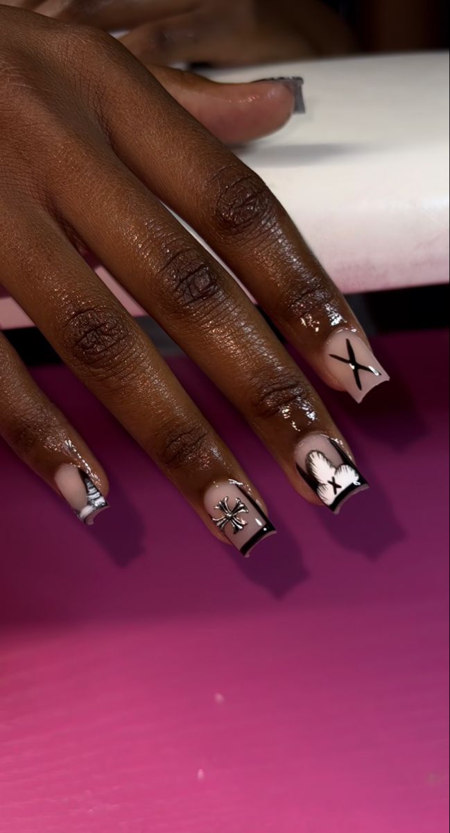 Chic Nail Design with Soft Nude Base and Artistic Black & White Motifs.