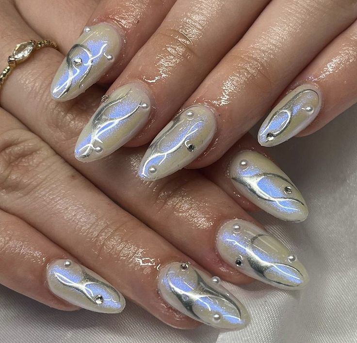 Sophisticated Iridescent Nail Design with Elegant Swirls and Gem Accents