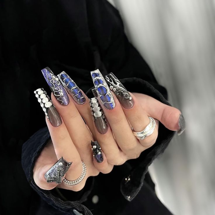 Elegant Long Nails: Intricate Designs in Deep Blues and Metallic Accents.