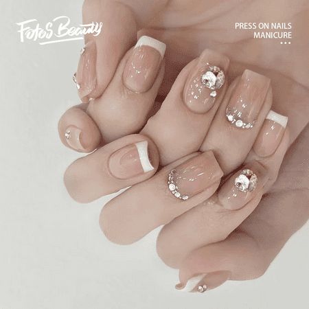 Sophisticated Elegant French Tip Manicure with Nude Base and Glamorous Rhinestones.