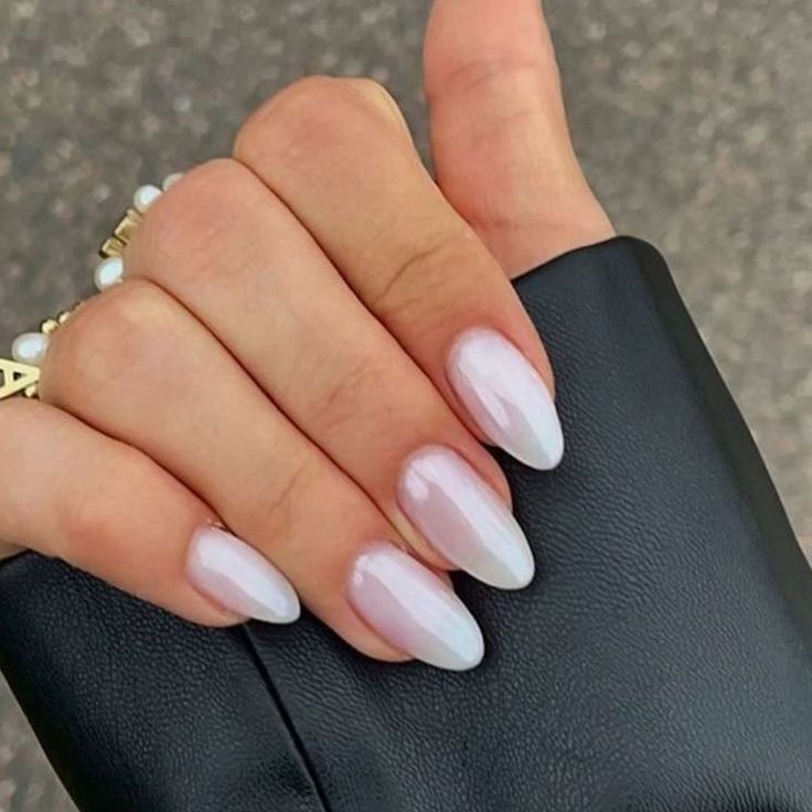 Chic Almond-Shaped Ombre Nails: Elegant Glossy Finish and Minimalist Accessory.