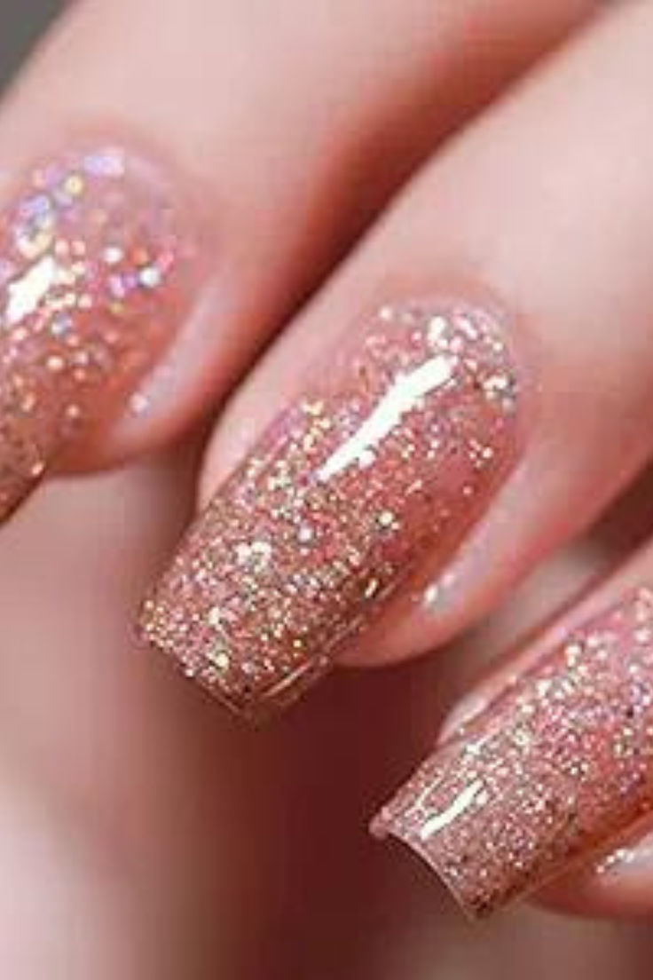 Glamorous Glittery Ombre Nails: Soft Pink and Shimmering Gold Blend for Stunning Elegance.