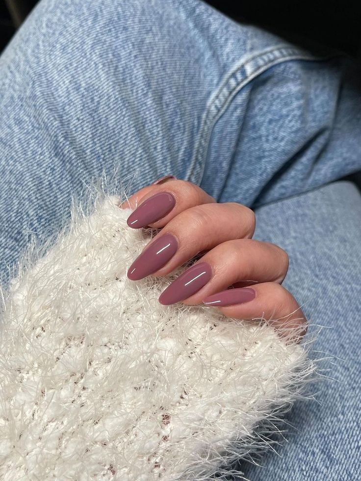 Sophisticated Almond-Shaped Nails in Muted Mauve Elevate Any Outfit.