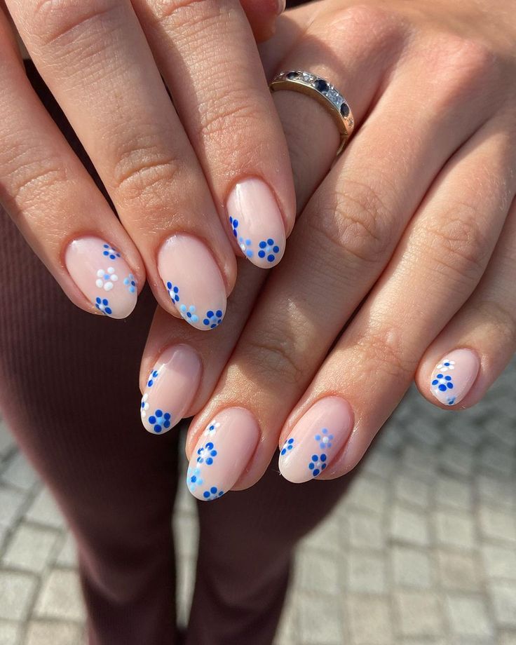 Charming Floral Nail Art: Soft Nude Base with Blue Flowers and Dots for a Fresh Look