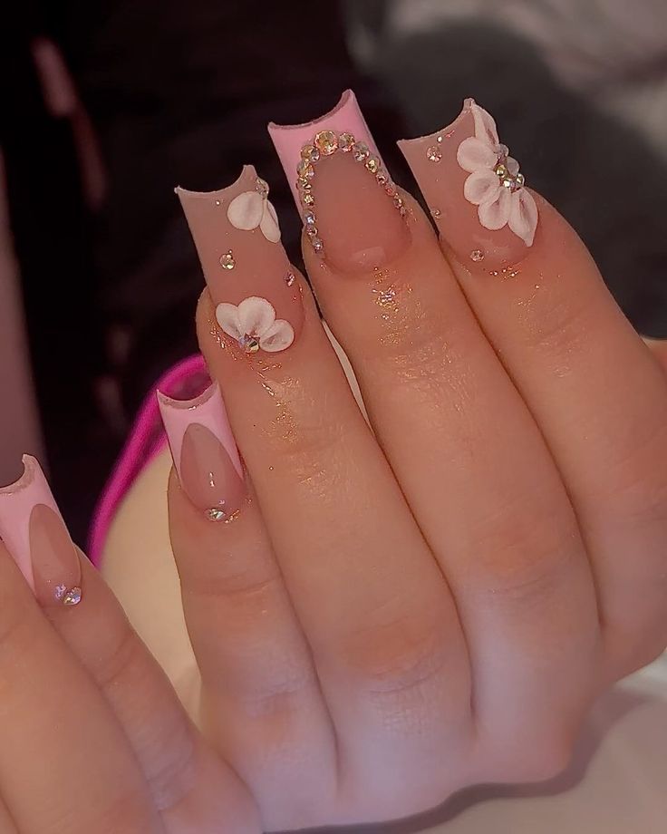 Sophisticated Floral Nail Design in Soft Pink and Natural Tones with Sparkling Gemstones.