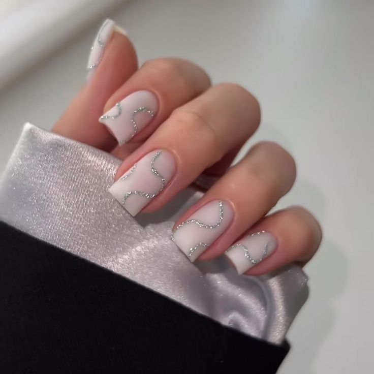 Sophisticated Soft White Nail Design with Sparkling Silver Accents