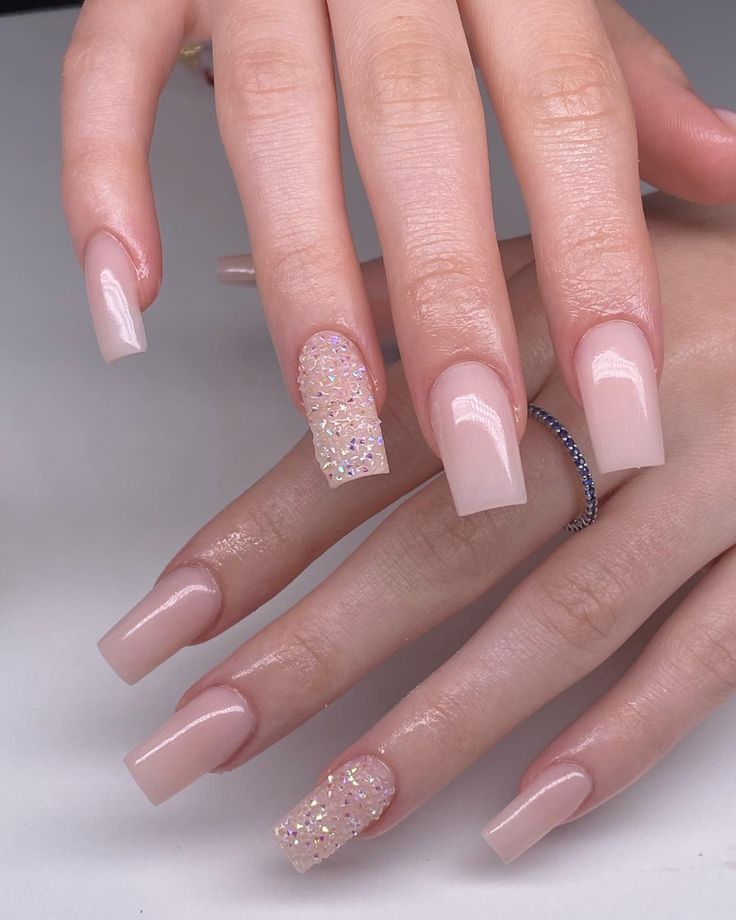 Sophisticated Nude Nail Design with Glamorous Sequin Accent