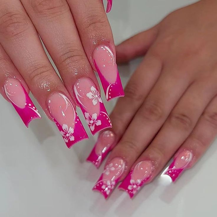 Elegant Pink Ombre Nails with Floral Accents for a Striking, Feminine Look