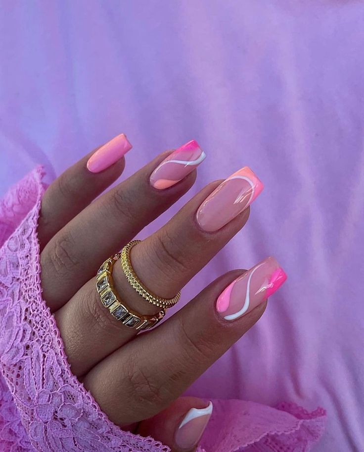 Chic Pink Nail Design with Intricate White Swirls and Ombre Shades.