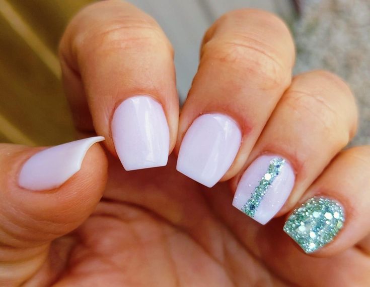 Chic Pastel Nail Design: Delicate Lavender Base with Sparkling Green Accent