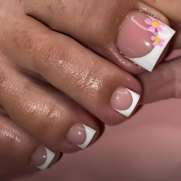 Whimsical Floral French Tip Nail Design in Soft Pink and Crisp White.