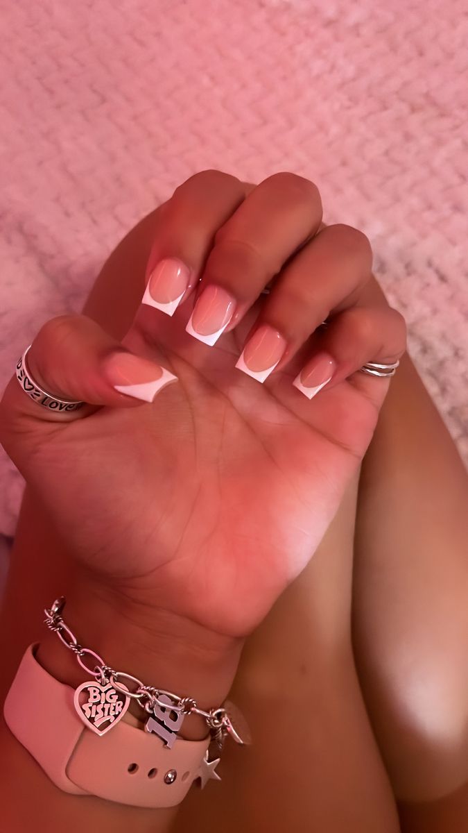 Chic Soft Pink and White Nail Design Accentuated by Delicate Jewelry.