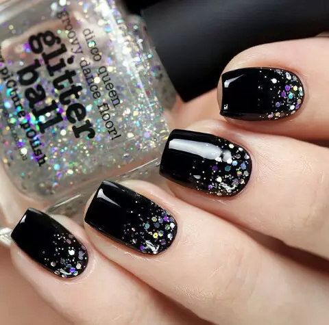 Glamorous Black Nail Design with Glossy Finish and Vibrant Glitter Cascade