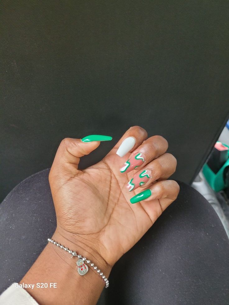 Bold and Trendy Green and White Almond-Shaped Nail Design with Playful Patterns.